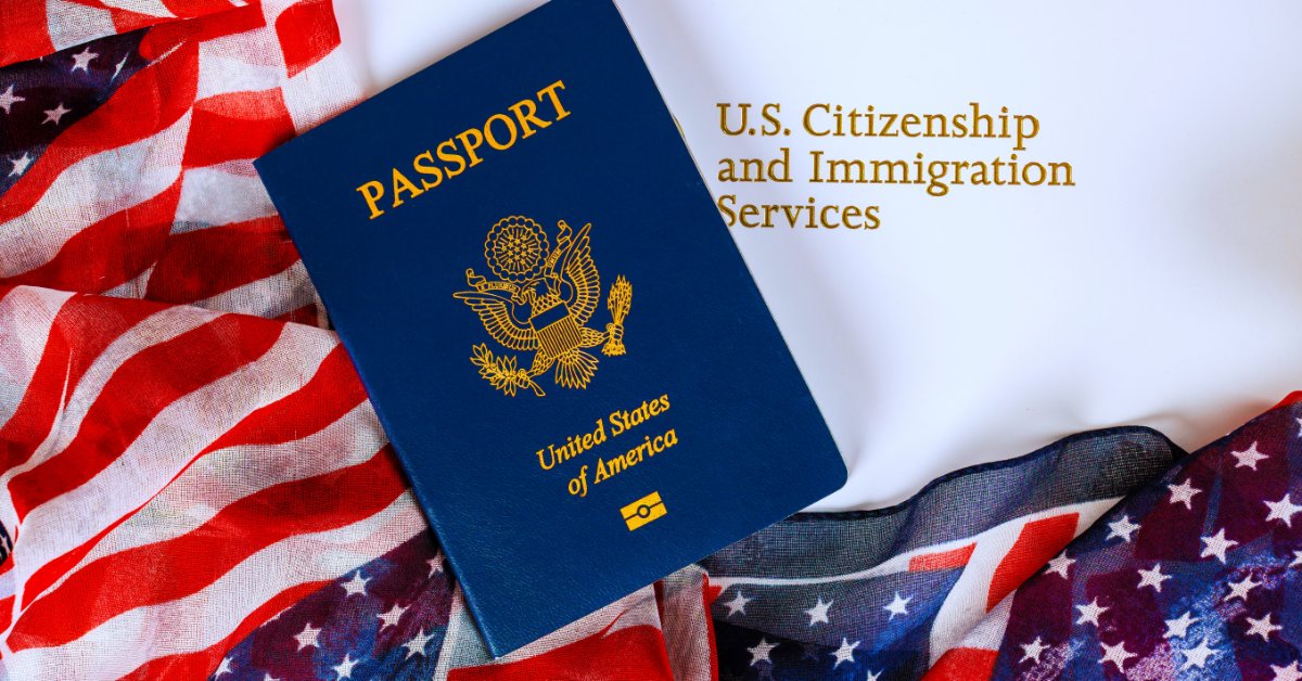 A United States passport lying on American flag fabric beside text reading U.S. Citizenship and Immigration Services.
