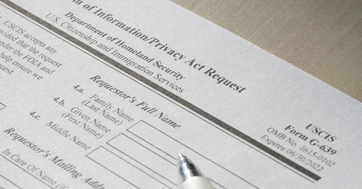 A close-up of a document labeled "Freedom of Information Request." The document contains blank text boxes for personal info.
