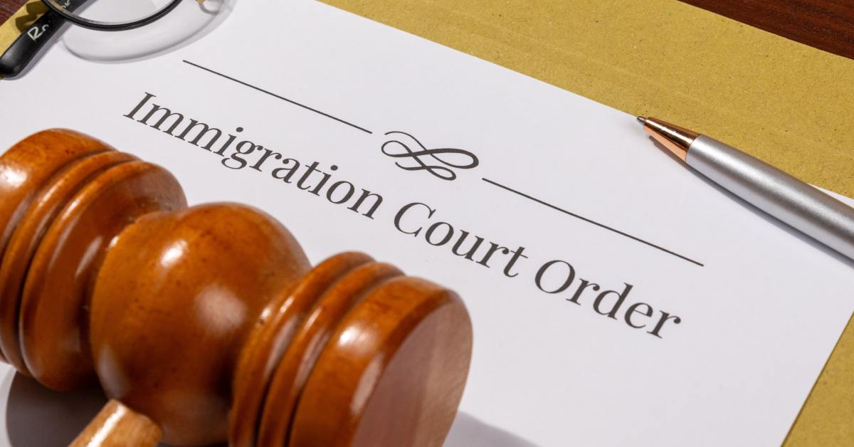 A court mandate paperwork for an immigration case with a gavel on the table, highlighting a legal ruling.