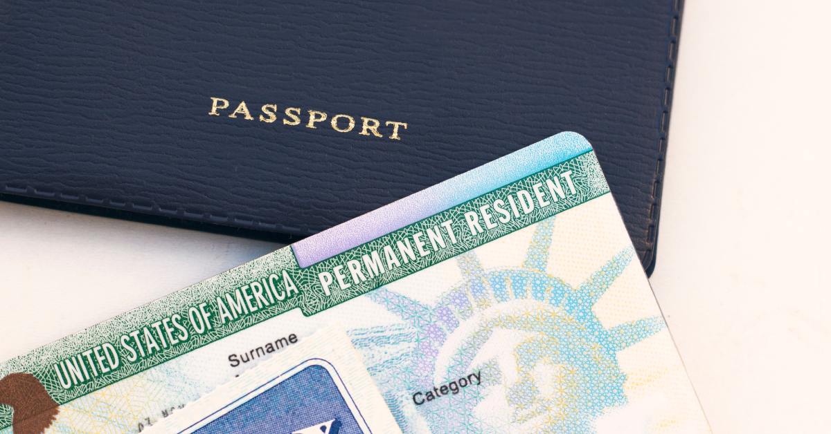 U.S. passport, Social Security card, and green card on a white background, symbolizing immigration status.