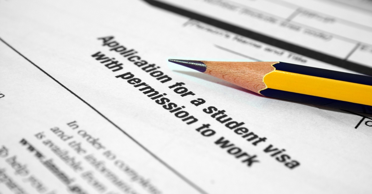 A document that says 'Application for a student visa with permission to work.' next to a yellow pencil.